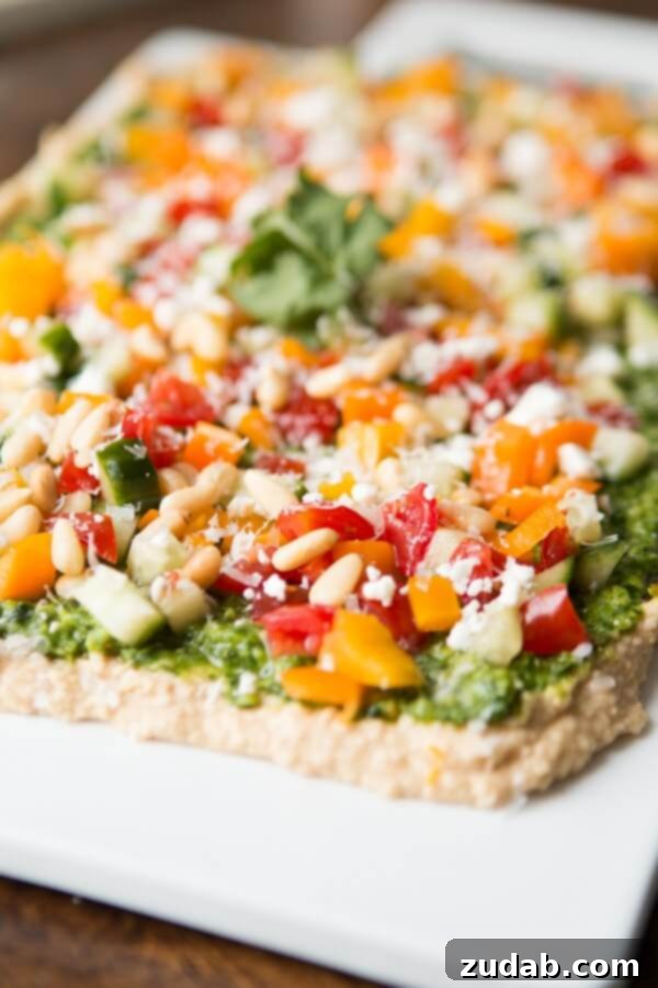 Homemade 8-Layer Hummus Dip Recipe Close-up of creamy 8-Layer Hummus Dip with colorful toppings