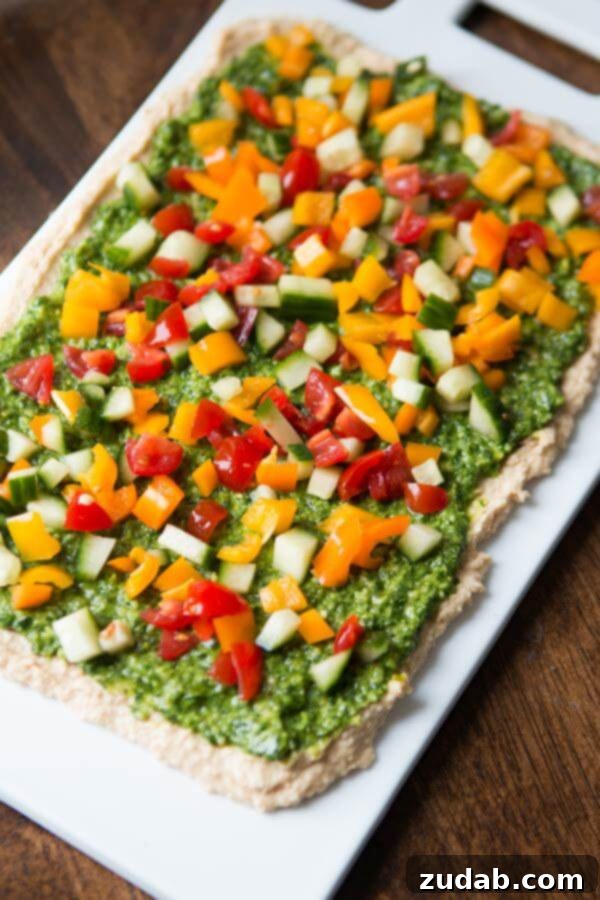 Fresh and Easy 8-Layer Hummus Dip 8-Layer Hummus Dip garnished with fresh cilantro and vibrant vegetables
