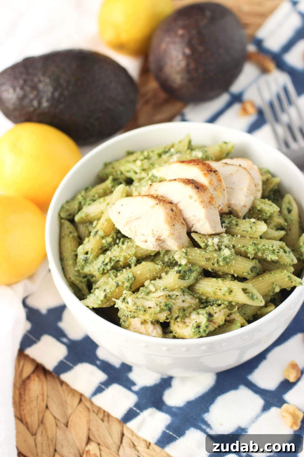 Creamy Avocado Pesto Chicken Pasta - A quick weeknight meal with a lighter, creamy sauce, perfect for using leftover chicken! This avocado pesto chicken pasta is a quick weeknight meal with a lighter and creamy sauce. A great way to use leftover chicken!