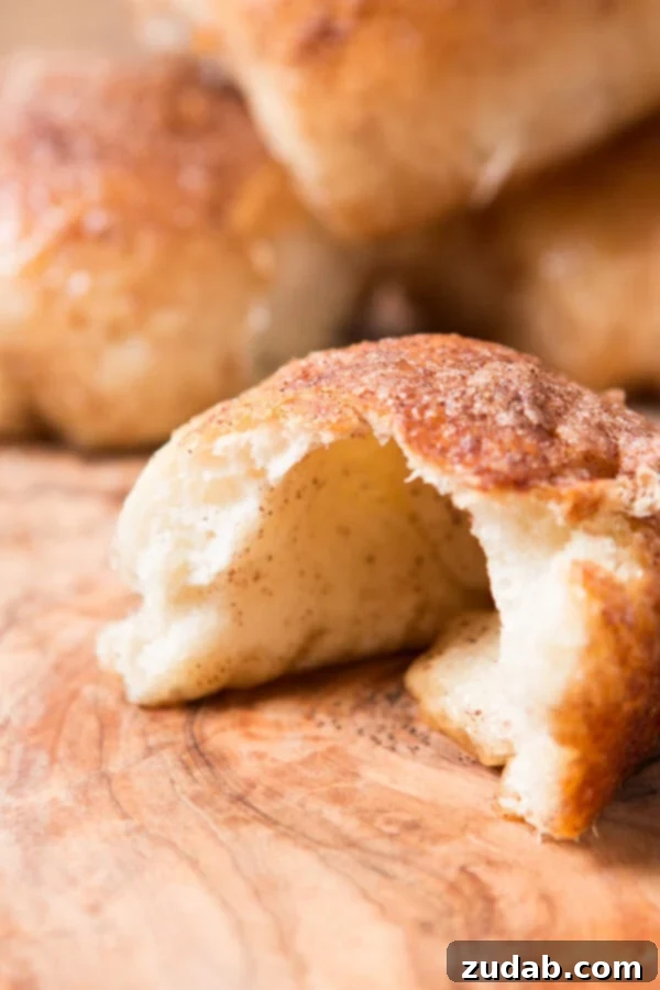Every Easter our family makes these sweet empty tomb rolls where the marshmallow melts down to a caramel sauce that's amazing! A perfectly baked cinnamon sugar resurrection roll, cut in half to reveal the hollow, caramelized interior where the marshmallow once was.
