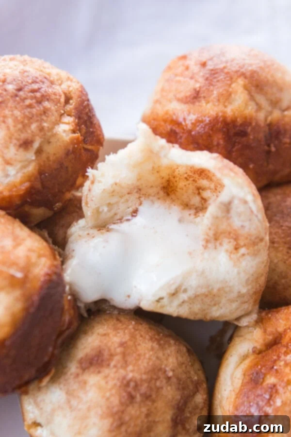 Every Easter our family makes these sweet empty tomb rolls where the marshmallow melts down to a caramel sauce that's amazing! A close-up view of an empty tomb roll, broken open to reveal the perfectly hollow center where the marshmallow disappeared, now filled with sweet caramel.