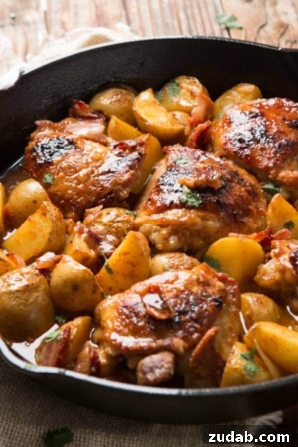 Hands down, our absolute most favorite recipe ever is this juicy, saucy braised dijon chicken and potatoes that's a one skillet wonder! paleo, whole 30 Braised chicken thighs and potatoes sizzling in a cast iron skillet, golden brown and saucy.