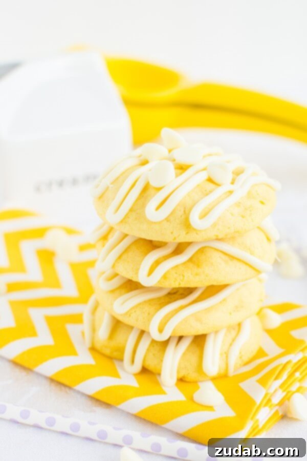 Closeup of Soft Lemon Cremesicle Cookie Interior Soft and chewy lemon cremesicle cookies stuffed with a sweet, tangy cream cheese filling and drizzled in white chocolate!