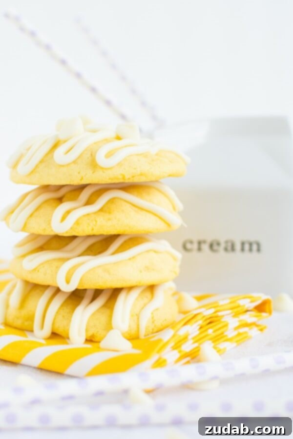 Lemon Cremesicle Cookie Halved to Show Cream Cheese Filling Soft and chewy lemon cremesicle cookies stuffed with a sweet, tangy cream cheese filling and drizzled in white chocolate!
