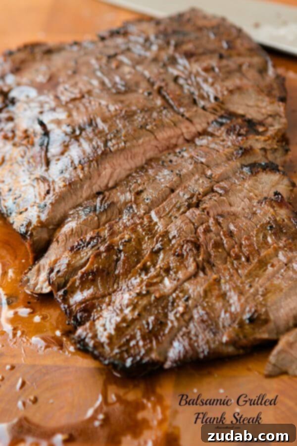 Marinated balsamic flank steak sizzling on the grill, incredibly delicious!