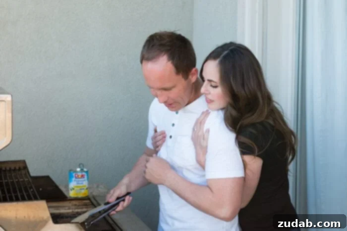A couple enjoying cooking together in the kitchen, preparing ingredients for kabobs.