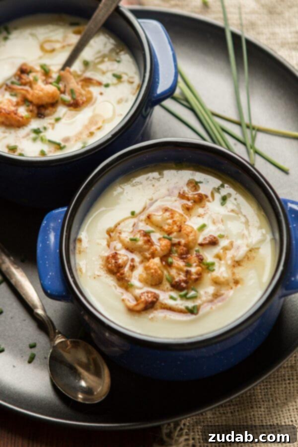 Brown butter cauliflower soup in a bowl with a spoon, ready to eat.