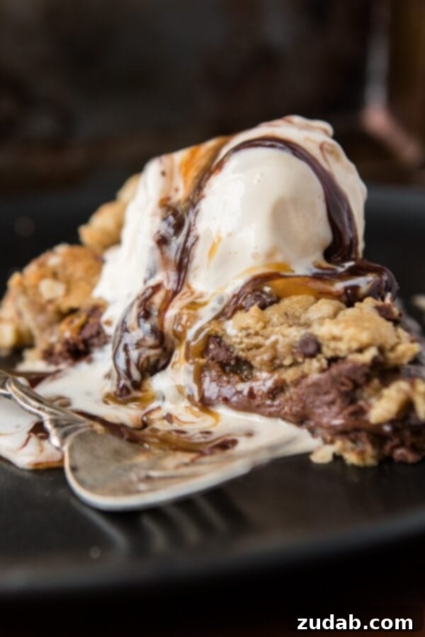 Layering Nutella and Dulce de Leche in a Pie A close-up of Nutella and dulce de leche being spread as layers within a pie crust, emphasizing the rich filling of the Nutella Dulce de Leche Chocolate Chip Cookie Pie.