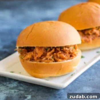 Quick & Easy BBQ Pulled Pork Pizza 3 Two Slow Cooker Pulled Pork Sandwiches on a white serving platter.