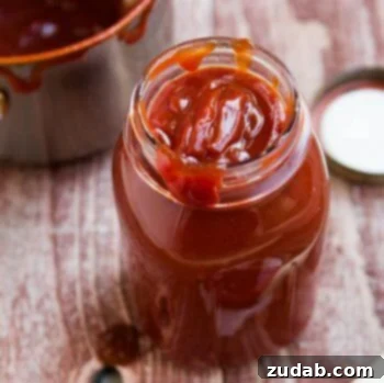 Quick & Easy BBQ Pulled Pork Pizza 4 Delicious Homemade BBQ Sauce in a clear glass jar on a wooden table.