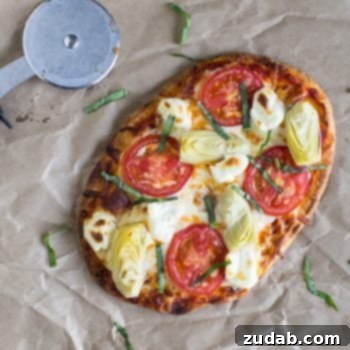 Quick & Easy BBQ Pulled Pork Pizza 6 Artichoke A La Mode Flatbread Pizza with healthy artichoke and tomatoes next to a pizza cutter.