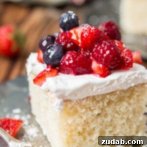 Beautiful Berry White Yogurt Cake with fresh fruit, ready to be served