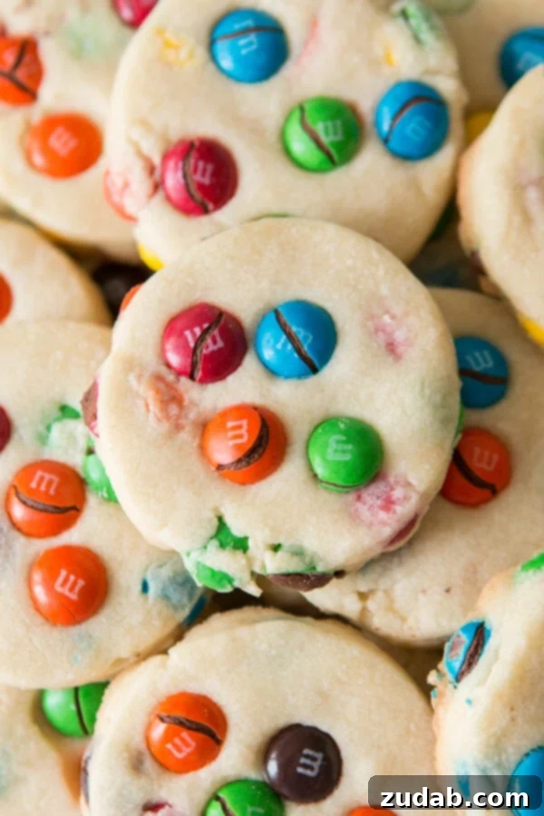 Buttery Shortbread M&M Cookies: A delightful treat for school lunches, picnics, or relaxing Sundays. Close-up of Shortbread M&M Cookies, showcasing their crumbly texture and colorful candies.
