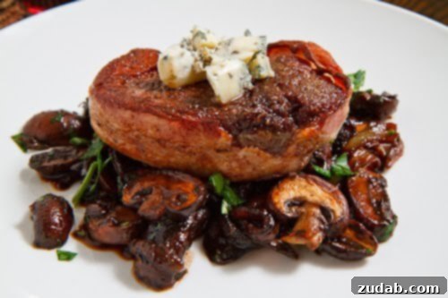 An exquisitely cooked Smoked Bacon Wrapped Filet, seared to perfection and ready to be served.