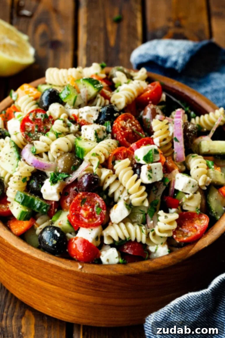 Greek Isles Pasta Salad 6 a photo of a large wooden bowl of greek pasta salad