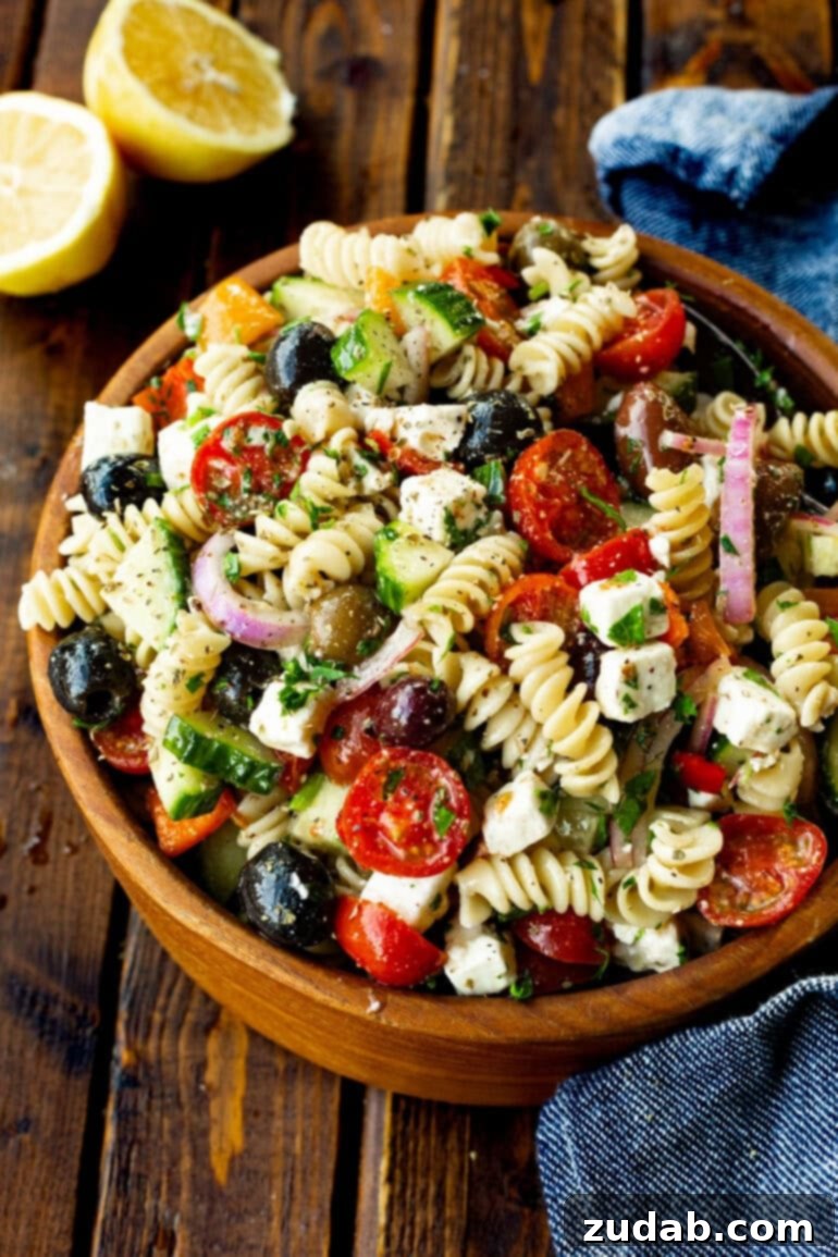 Greek Isles Pasta Salad 7 a photo of a greek pasta salad in a large wooden serving bowl