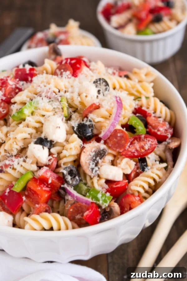 Serve Pizza Pasta Salad at your next barbecue and enjoy the delicious flavors of an Everything Pizza in this veggie, pepperoni, and cheese filled side dish. ohsweetbasil.com