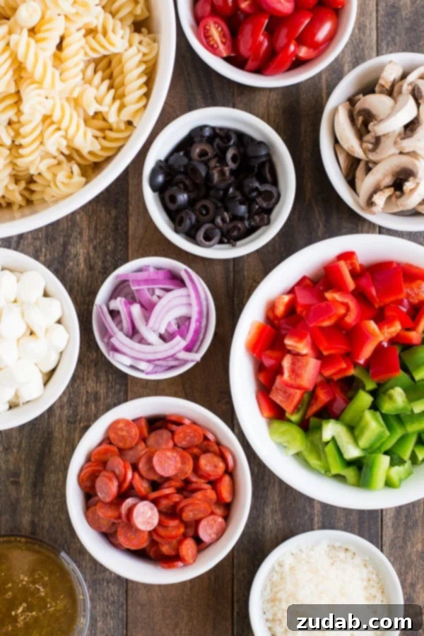 Serve Pizza Pasta Salad at your next barbecue and enjoy the delicious flavors of an Everything Pizza in this veggie, pepperoni, and cheese filled side dish. ohsweetbasil.com