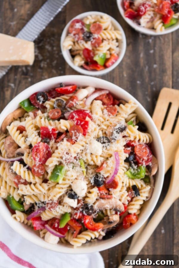 Serve Pizza Pasta Salad at your next barbecue and enjoy the delicious flavors of an Everything Pizza in this veggie, pepperoni, and cheese filled side dish. ohsweetbasil.com