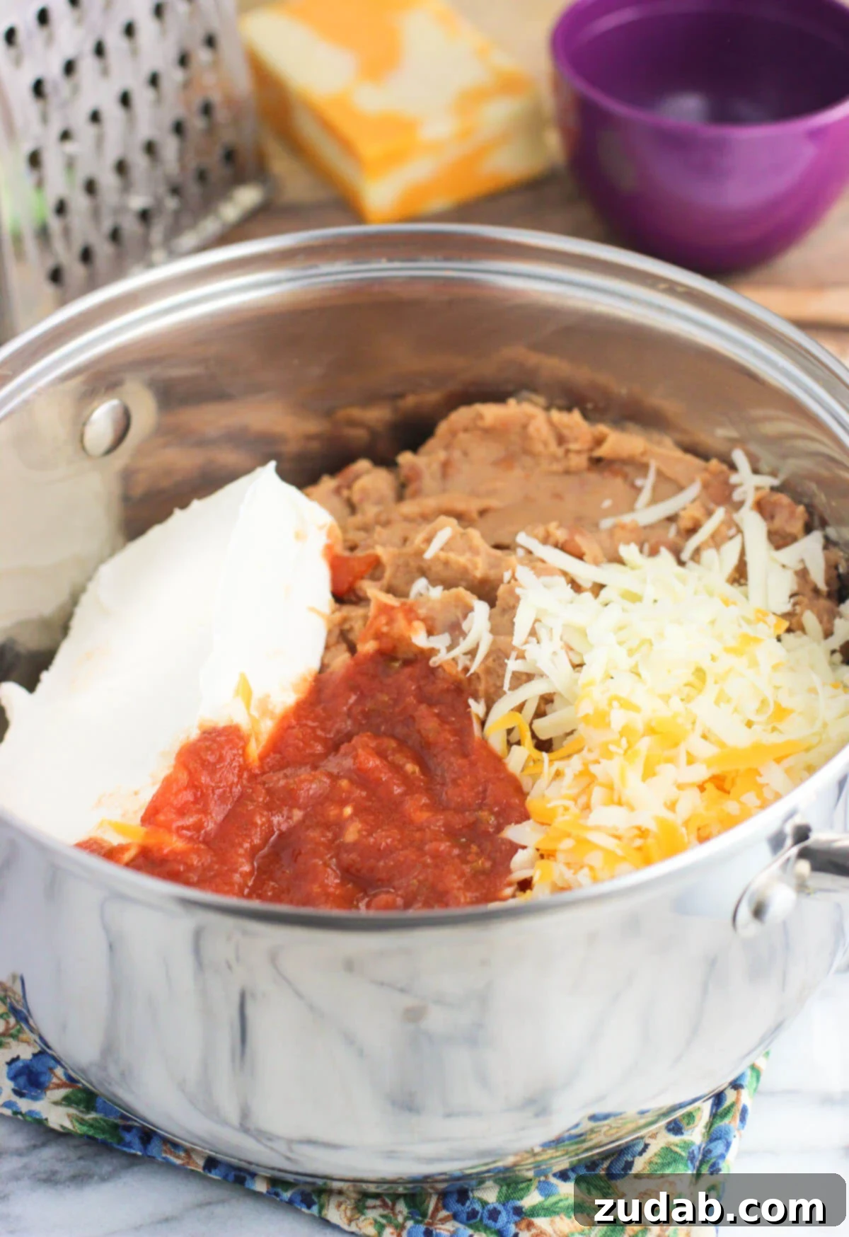 Ultimate Cheesy Bean Dip 3 This cheesy salsa bean dip is a dip recipe perfect for entertaining! It's easy, cheesy, and just thick enough for a satisfying and customizable appetizer or snack.