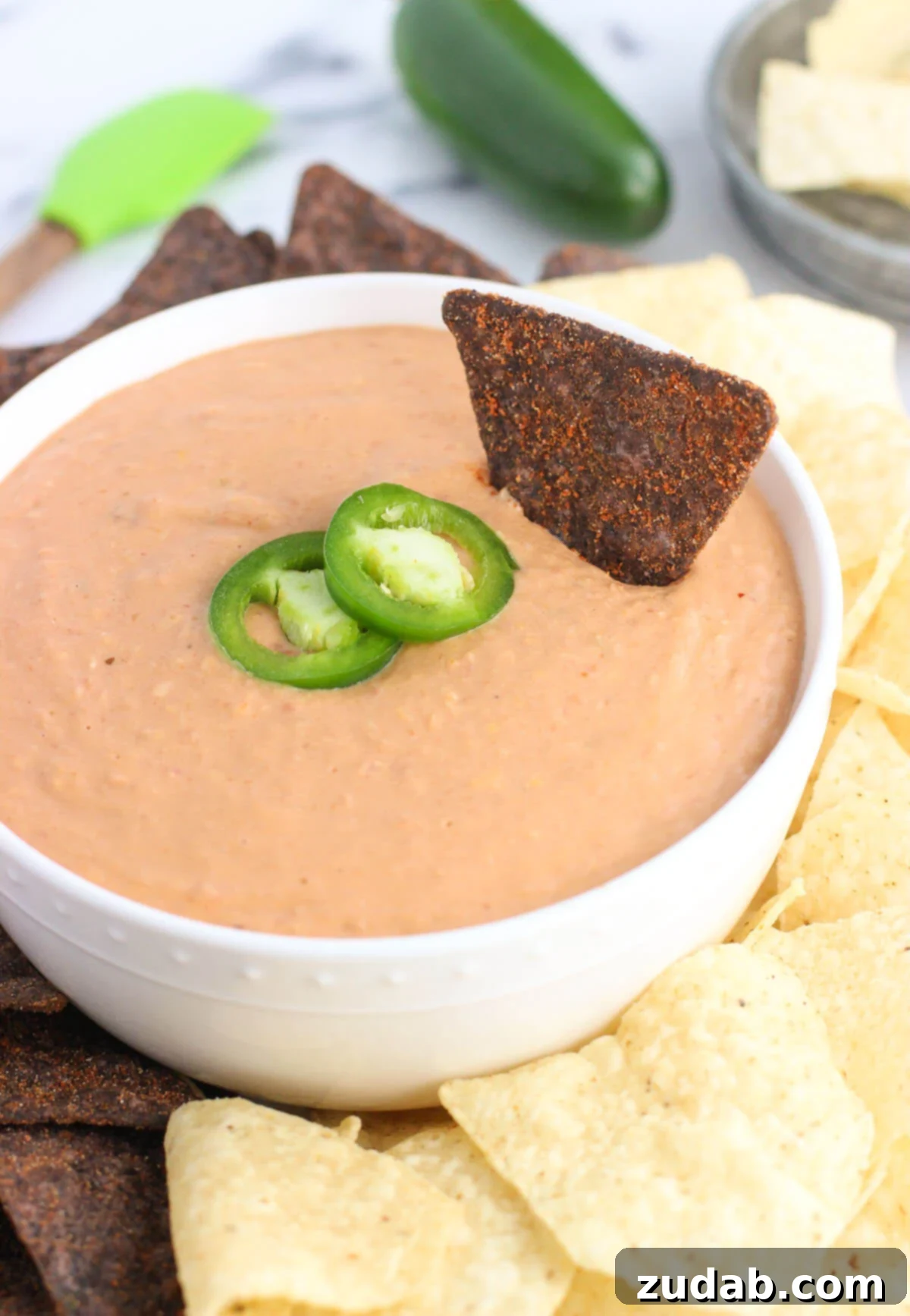 Ultimate Cheesy Bean Dip 4 This cheesy salsa bean dip is a dip recipe perfect for entertaining! It's easy, cheesy, and just thick enough for a satisfying and customizable appetizer or snack.