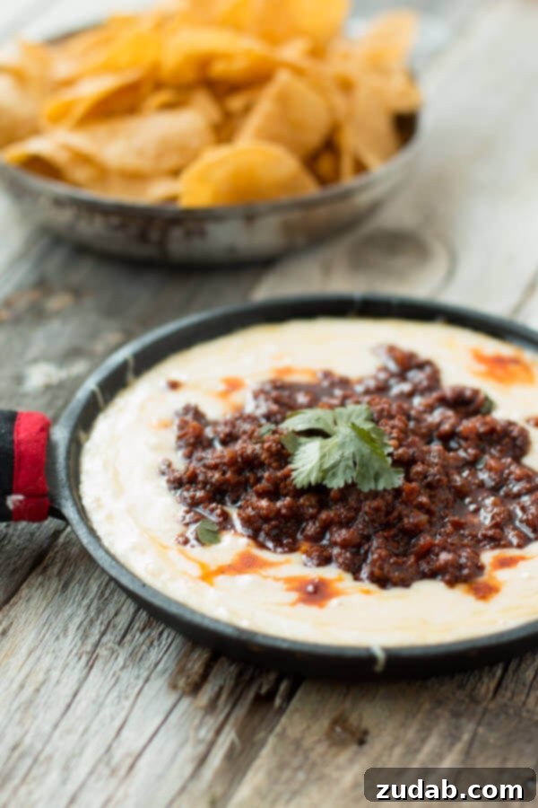 Ultimate Cheesy Bean Dip 7 A bowl of chorizo dip - queso fundido with tortilla chips