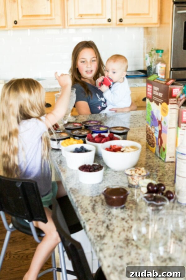 Ingredients for a healthy breakfast parfait: Mom's Best Cereal, fresh berries, and creamy Greek yogurt.