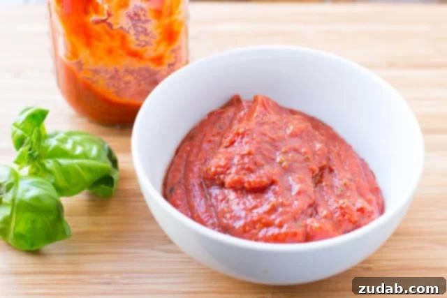 Wholesome Zucchini Pizza Base 5 A bowl of rich, homemade pizza sauce, simmering with aromatic herbs and spices, promises a secret ingredient for exceptional flavor.