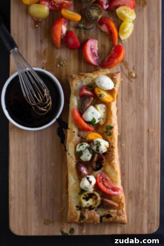 Rustic Mozzarella Tomato Tart 7 Heriloom tomatoes, puff pastry, marinated mozzarella and balsamic reduction and guess what, all of it is premade and you can whip it all together. ohsweetbasil.com_-3
