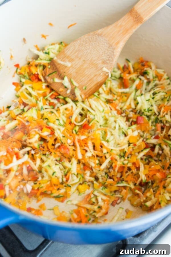 Make healthy eating fun! This garden veggie marinara sauce is perfect for pizza and spaghetti. ohsweetbasil.com A Pinterest-style graphic showcasing a delicious plate of spaghetti with garden veggie marinara sauce, encouraging more vegetable consumption for kids.