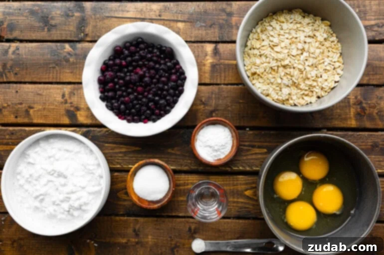 Protein-Packed Wild Blueberry Cottage Cheese Pancakes 4 A photo of all the wholesome ingredients for healthy wild blueberry cottage cheese pancakes, neatly arranged in separate bowls on a rustic table, ready for preparation.