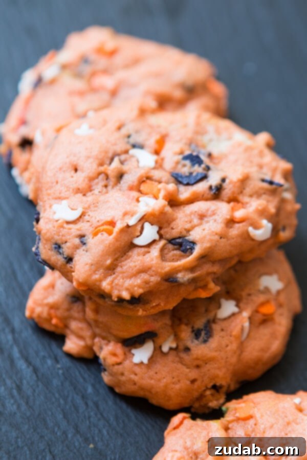 Spooky Sweet: Halloween Marshmallow Toffee Cookies Girls' Halloween-themed marshmallow toffee cookies with orange dough and festive sprinkles
