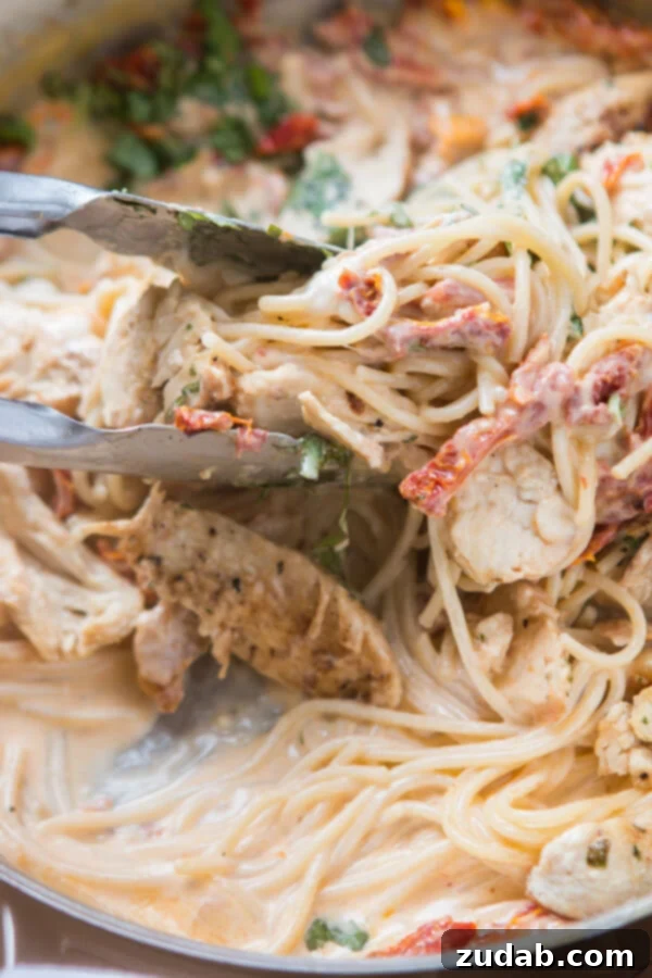 Velvety Sun-Dried Tomato Chicken Pasta in Minutes 8 Pouring heavy cream into a pan for the pasta sauce