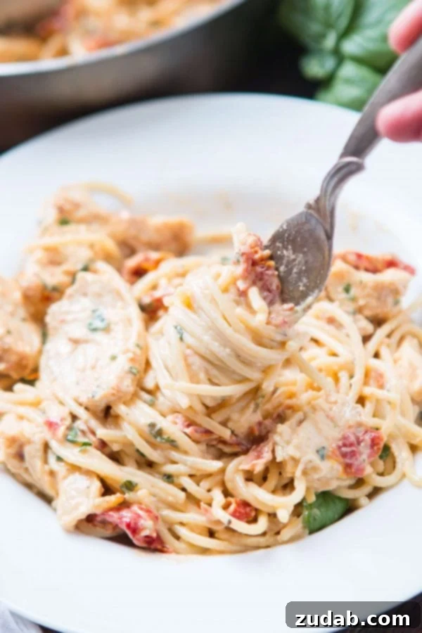 Velvety Sun-Dried Tomato Chicken Pasta in Minutes 9 Sautéed chicken breasts in a skillet, ready for slicing