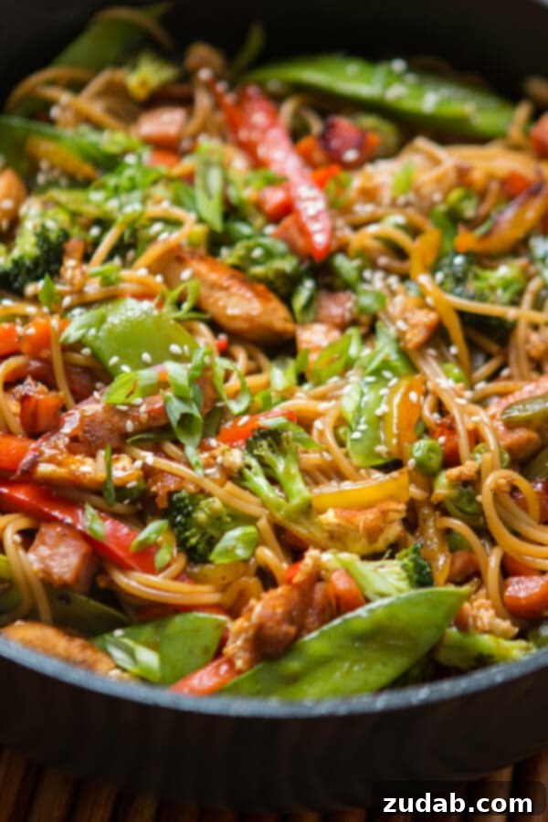 Sizzling Teriyaki Chicken Noodles: Your New Weeknight Favorite! A close-up shot of Teriyaki Chicken Noodles, highlighting the glossy sauce, tender chicken, and colorful vegetables.