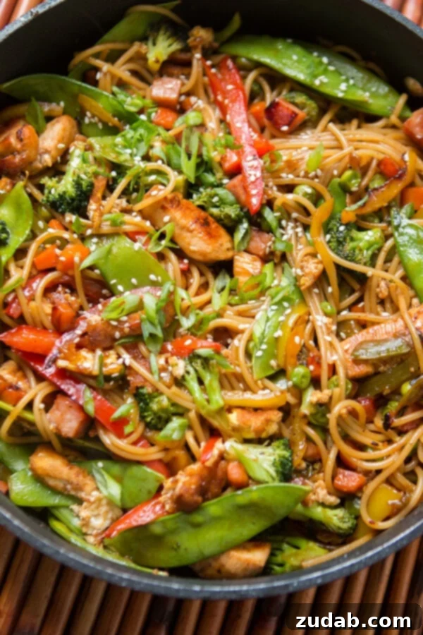 Teriyaki Chicken Noodles with Scrambled Egg A close-up of Teriyaki Chicken Noodles, showing the scrambled egg mixed in with the other ingredients, adding texture and flavor.