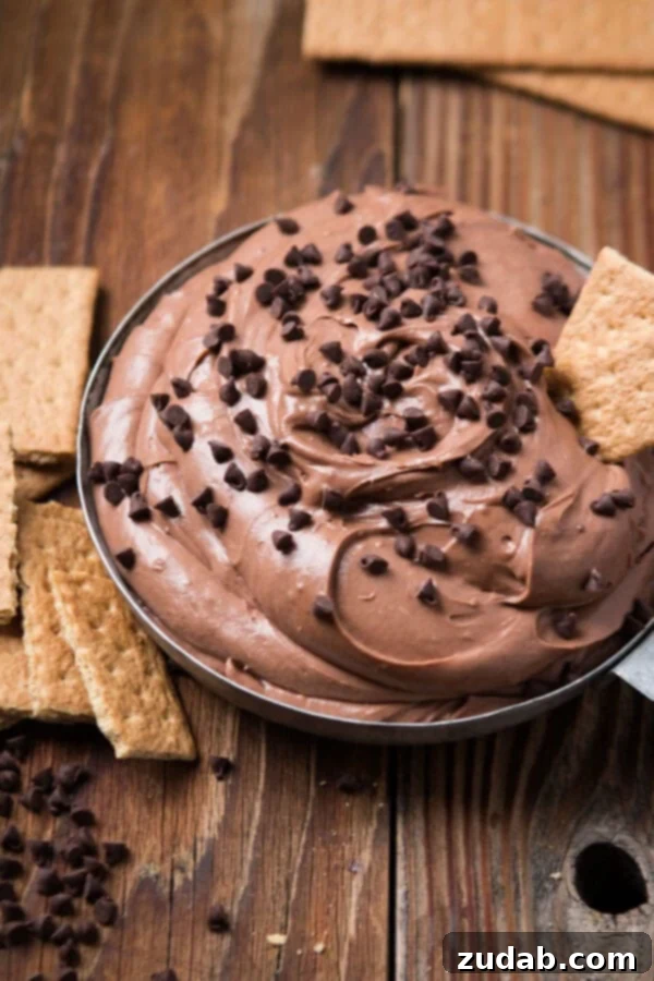 This is your new go-to for appetizers, party food, easy dips, and treat for the holidays. It takes no time to make Brownie Batter Dip! A festive display of creamy brownie dessert dip surrounded by crisp graham crackers and sprinkled with chocolate chips, perfect for sharing.
