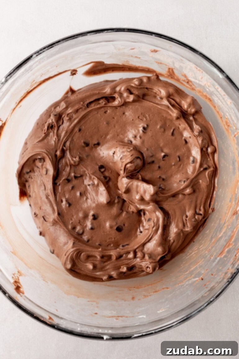 Decadent Brownie Batter Dip 8 The final step of gently folding mini chocolate chips into the brownie batter dip mixture.