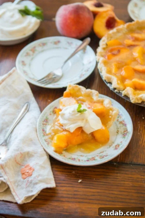Delicious Lemon Jello Peach Pie slice, ready to be served Close-up of a slice of Lemon Jello Peach Pie, showcasing the vibrant peach filling