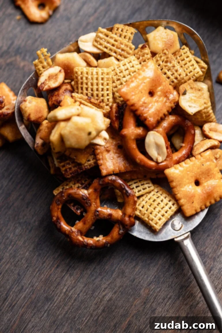 Whip Up Easy Ranch Chex Mix in Your Slow Cooker 2 A vibrant snack mix featuring crispy Chex cereal, crunchy pretzels, buttery oyster crackers, cheesy Cheez-Its, and roasted peanuts, all coated in a savory ranch seasoning blend. This slow cooker Chex mix is perfect for parties and game days.