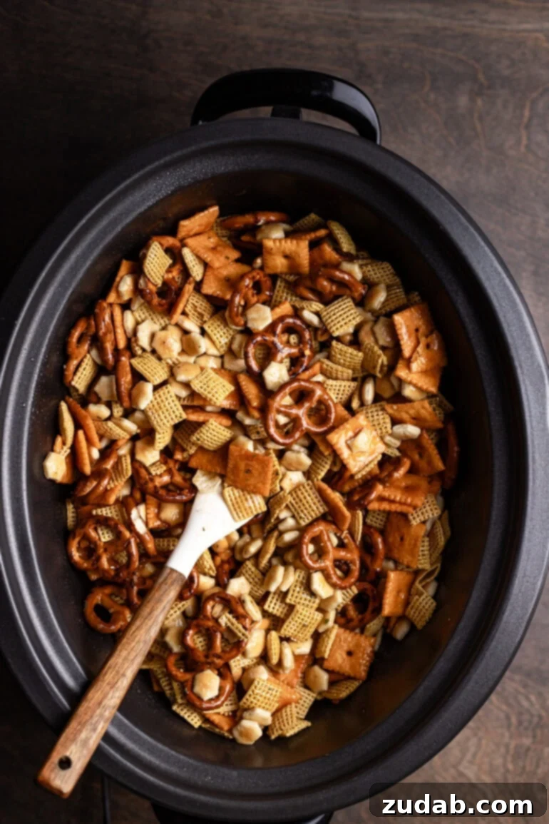 Every party needs something sweet, something salty, something light, and something indulgent. This ranch slow cooker Chex mix perfectly embodies both salty and addicting qualities, making it a truly essential party snack! A crock pot filled with a tantalizing assortment of Chex cereal, pretzels, savory oyster crackers, cheesy Cheez-Its, and crunchy peanuts, all generously coated in a vibrant ranch seasoning blend. This is undoubtedly the best Chex mix recipe for any occasion!