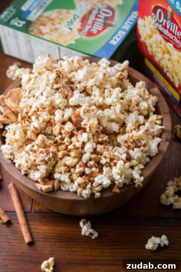 The perfect bite: Easy Apple Pie Popcorn detail. A close-up of a single kernel of Easy Apple Pie Popcorn, showcasing the delicate coating. ohsweetbasil.com