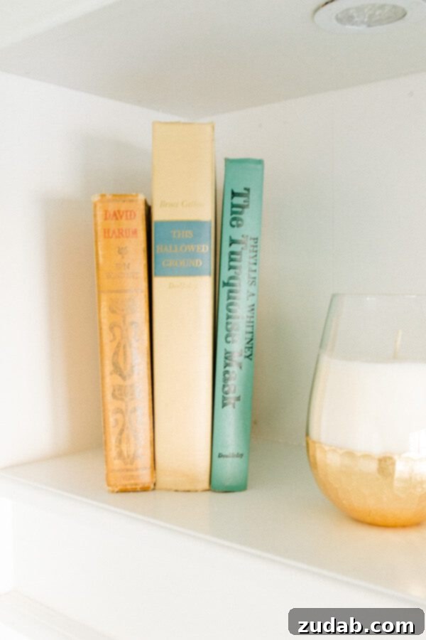 My New Office Tour 8 Close-up of vintage books on a shelf, adding character and warmth to the home office decor.