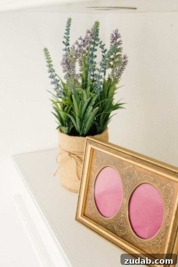 My New Office Tour 10 A refined home office space with a focus on comfortable seating, a stylish pouf, and cohesive color palette.