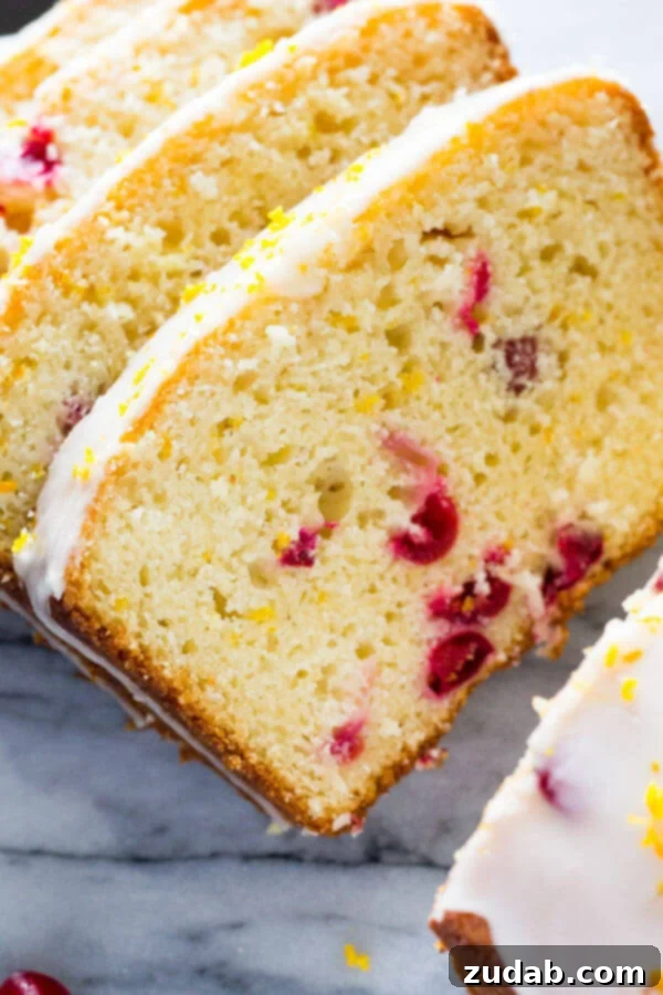 Vibrant Cranberry Orange Cake with Cream Cheese Frosting 8 A glazed cranberry orange loaf, incredibly soft and moist due to the inclusion of sour cream, making it a must-have for your holiday baking list.