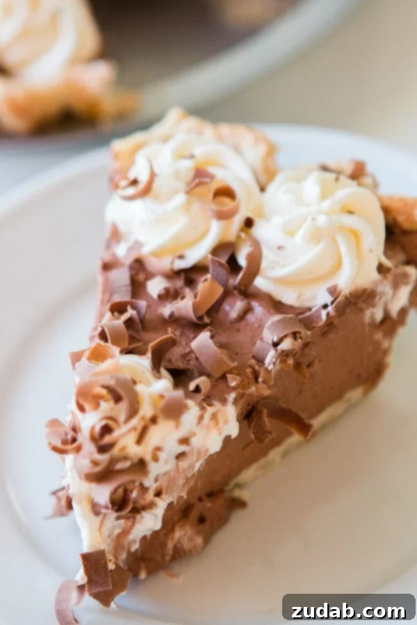 Learn how to make an easy no-bake chocolate pie with chocolate Jell-O pudding and stabilized whipped cream for a stunning dessert. A close-up of a delightful slice of no-bake chocolate pie, featuring layers of creamy chocolate filling and a fluffy stabilized whipped cream topping, ready to be enjoyed.