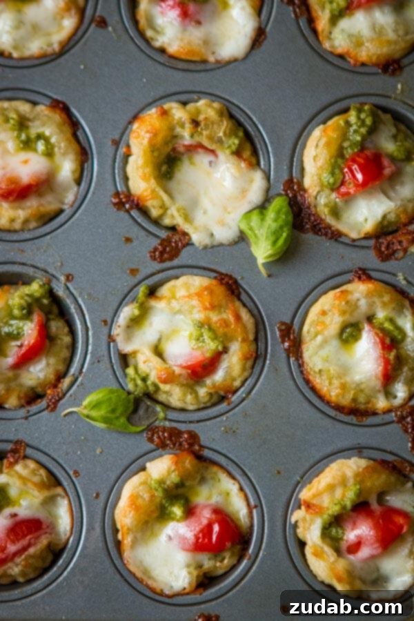 Speedy Cheesy Caprese Pesto Tarts 6 A close-up shot of Pecorino Romano cheese, either grated or in a substantial block, showcasing its granular texture and suggesting its savory depth for a dish like pesto tarts.