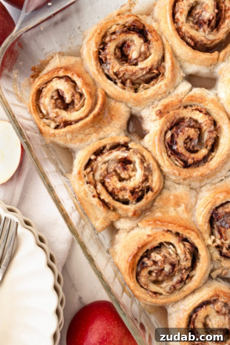 Rustic Orchard Apple Swirls 4 A glass baking dish brimming with golden-baked, sweet apple rolls, delicately topped with a simple glaze. Their no-yeast preparation makes them quick and easy.