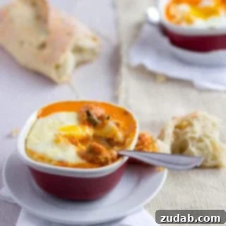 Delicious baked eggs ready to serve with fresh herbs
