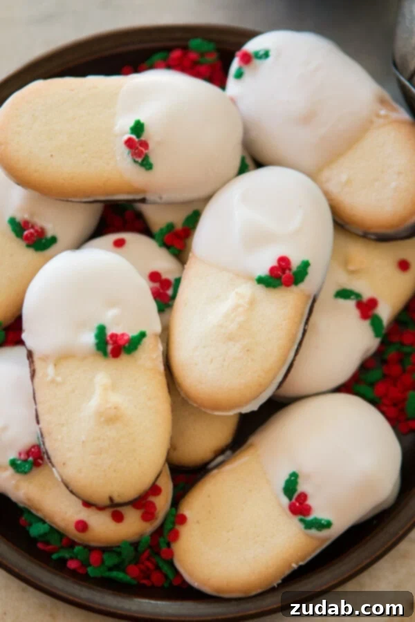 The joy of giving, beautifully presented in White Chocolate Dipped Mint Milanos. ohsweetbasil.com White Chocolate Dipped Mint Milanos resting on a serving tray, perfect for sharing during festive gatherings or as a heartfelt, homemade gift. ohsweetbasil.com